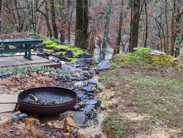 view of yard with a fire pit