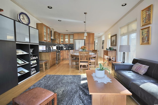 living area with light wood-style flooring and recessed lighting