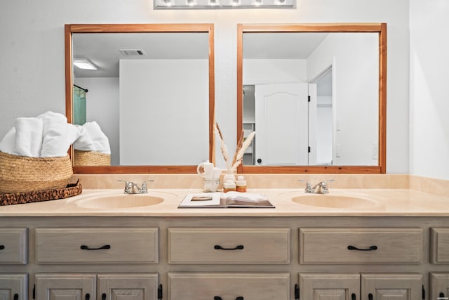 bathroom featuring double vanity, a sink, and visible vents