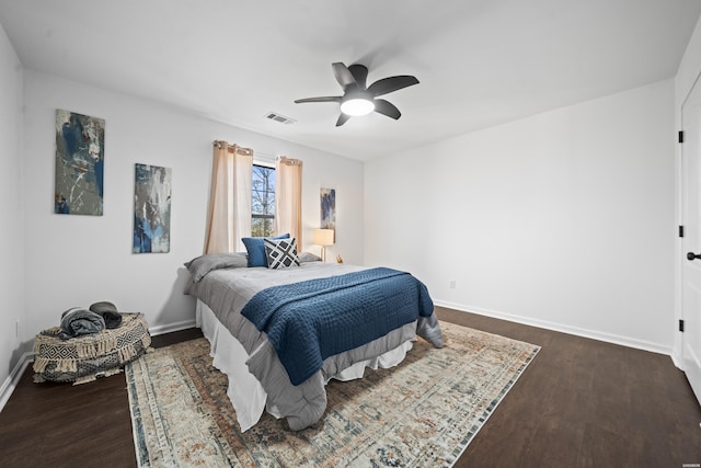 bedroom featuring dark wood-style flooring, visible vents, and baseboards