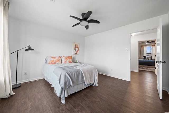 bedroom with dark wood-style flooring, a ceiling fan, and baseboards