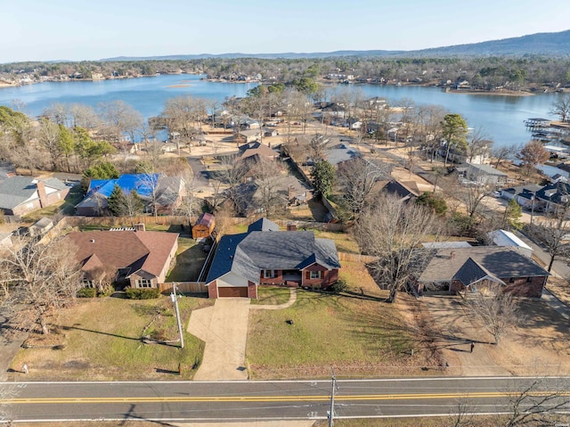 birds eye view of property with a water view and a residential view