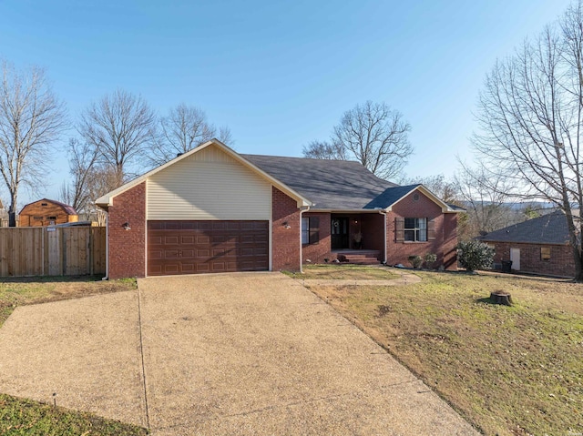 single story home with brick siding, an attached garage, a front yard, fence, and driveway