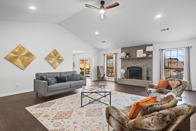 living room with dark wood finished floors, visible vents, and a fireplace