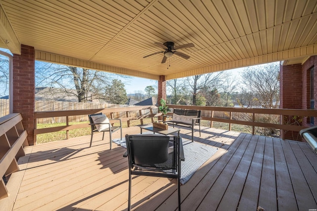 deck featuring ceiling fan and fence