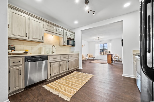 kitchen featuring tasteful backsplash, light countertops, stainless steel dishwasher, dark wood-type flooring, and black microwave