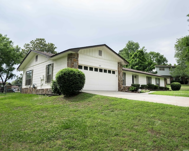 view of front facade featuring a garage, driveway, stone siding, a front lawn, and board and batten siding