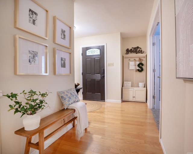 entrance foyer featuring light wood-type flooring and baseboards