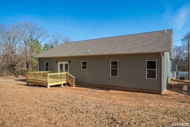 back of property featuring crawl space, a shingled roof, a deck, and french doors