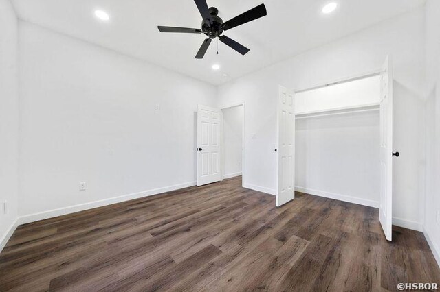 unfurnished bedroom with dark wood-type flooring, recessed lighting, a closet, and baseboards