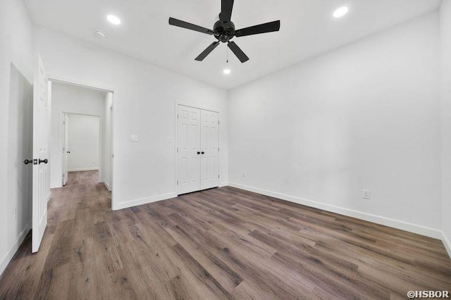 unfurnished bedroom with baseboards, dark wood finished floors, and recessed lighting