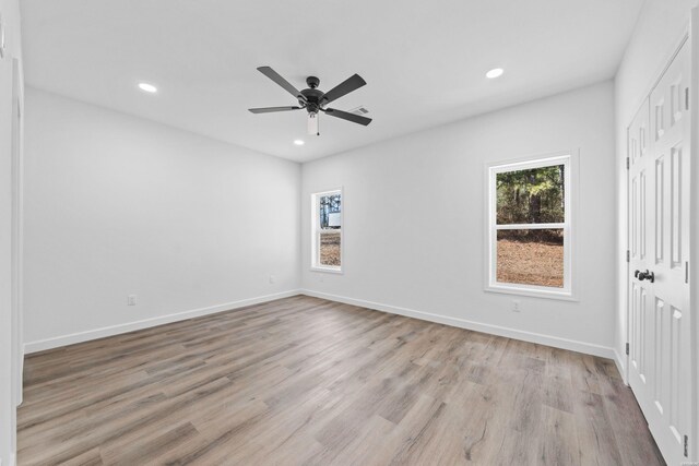 spare room with a ceiling fan, recessed lighting, baseboards, and light wood finished floors