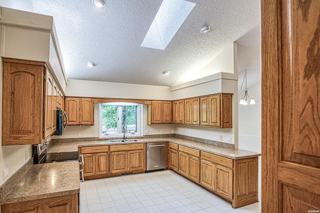 kitchen featuring a sink, appliances with stainless steel finishes, brown cabinets, and a textured ceiling