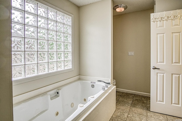 full bathroom featuring a whirlpool tub, baseboards, and plenty of natural light