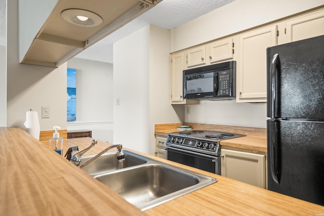 5371 Central Ave Unit 5K, Hot Springs, AR 71913 - kitchen featuring black appliances, butcher block counters, a textured ceiling, and white cabinets