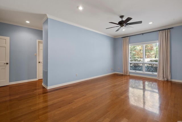 spare room featuring ornamental molding, recessed lighting, wood finished floors, and baseboards