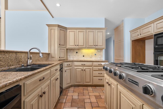 kitchen with recessed lighting, backsplash, cream cabinets, a sink, and black appliances