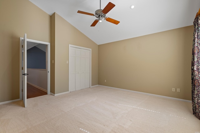 unfurnished bedroom featuring a closet, a ceiling fan, carpet flooring, high vaulted ceiling, and baseboards