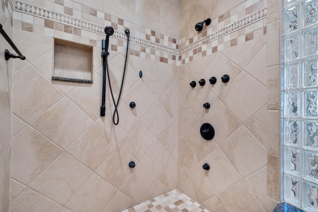 bathroom with a tile shower