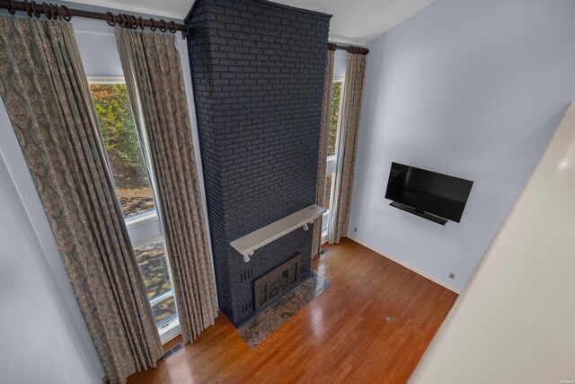 living room with visible vents, plenty of natural light, and wood finished floors