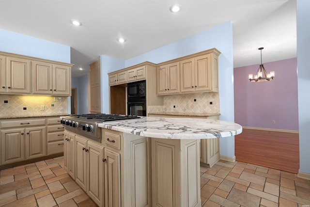 kitchen featuring stone tile floors, baseboards, cream cabinets, black appliances, and recessed lighting