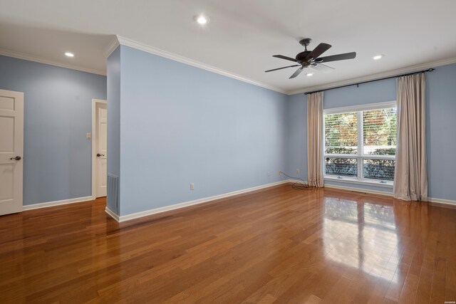 empty room with crown molding, baseboards, wood finished floors, and recessed lighting