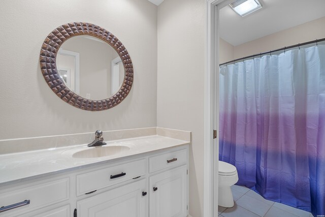 bathroom featuring a shower with shower curtain, vanity, toilet, and tile patterned floors