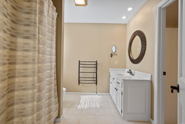 bathroom featuring tile patterned flooring, toilet, recessed lighting, vanity, and baseboards