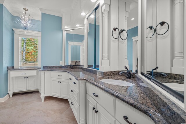 bathroom with double vanity, ornamental molding, and a sink