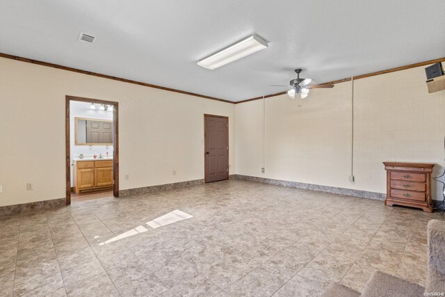 empty room featuring baseboards, ceiling fan, visible vents, and crown molding