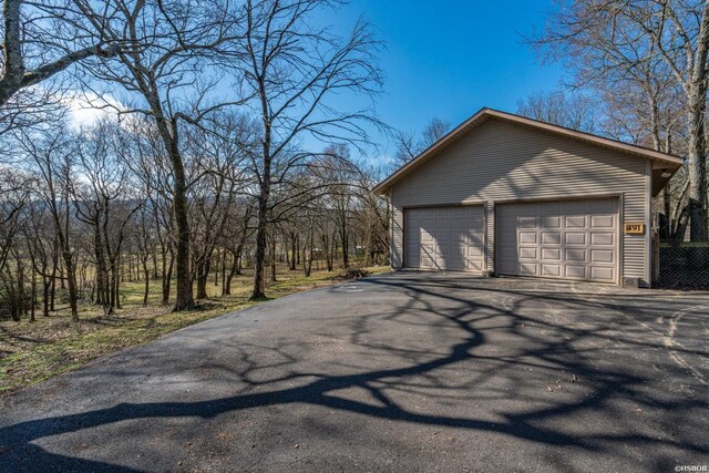 view of side of home with a garage and an outdoor structure