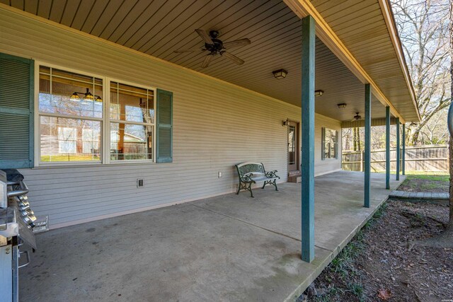 view of patio / terrace with fence and a ceiling fan