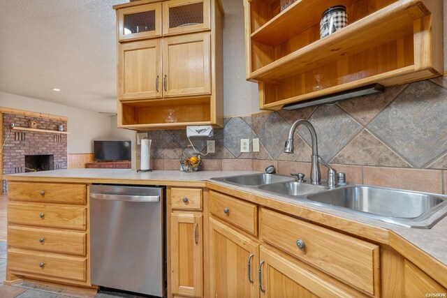 kitchen with tasteful backsplash, dishwasher, light countertops, open shelves, and a sink