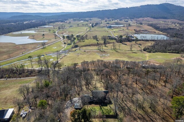 drone / aerial view with a water and mountain view and a rural view