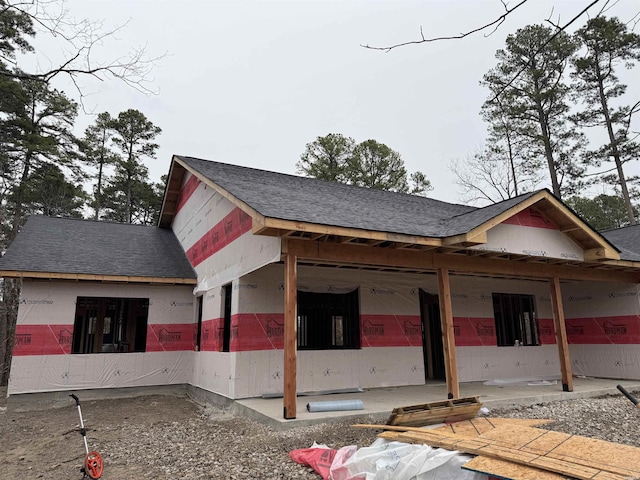 view of side of property with a shingled roof