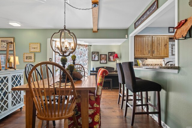 dining area featuring dark wood-type flooring, beam ceiling, and a notable chandelier