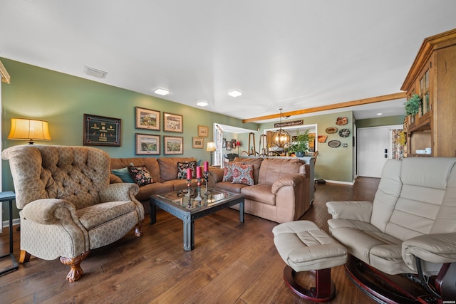 living room featuring visible vents, dark wood finished floors, and baseboards