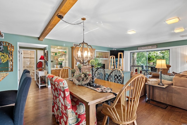 dining area with a notable chandelier, visible vents, wood finished floors, and beamed ceiling