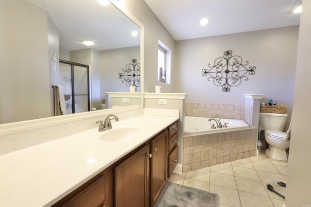 bathroom featuring toilet, a shower stall, vanity, a bath, and tile patterned floors