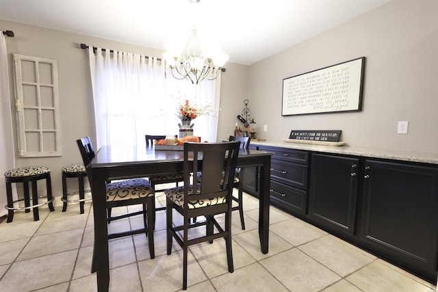 dining area with light tile patterned flooring and a notable chandelier