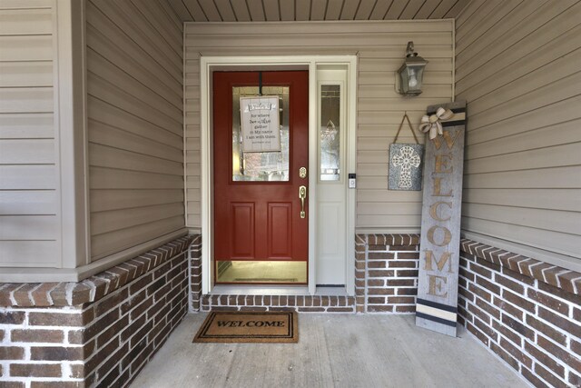 property entrance featuring brick siding