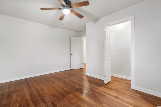 unfurnished bedroom with ceiling fan, baseboards, crown molding, and wood finished floors