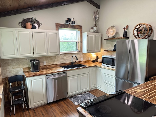 324 Quapaw Rd, Bismarck, AR 71929 - kitchen with appliances with stainless steel finishes, wooden counters, decorative backsplash, vaulted ceiling, and white cabinets