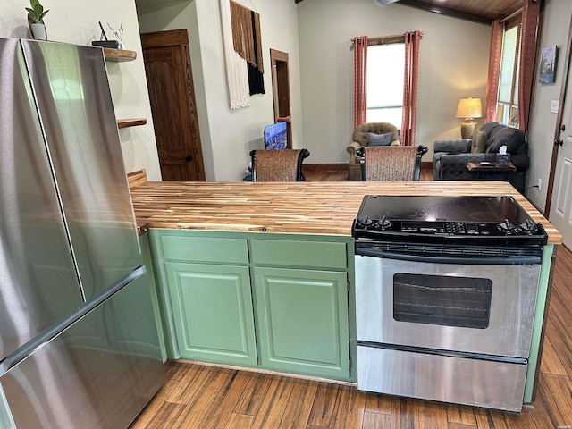 324 Quapaw Rd, Bismarck, AR 71929 - kitchen with stainless steel appliances, butcher block counters, dark wood-style floors, vaulted ceiling, and open floor plan