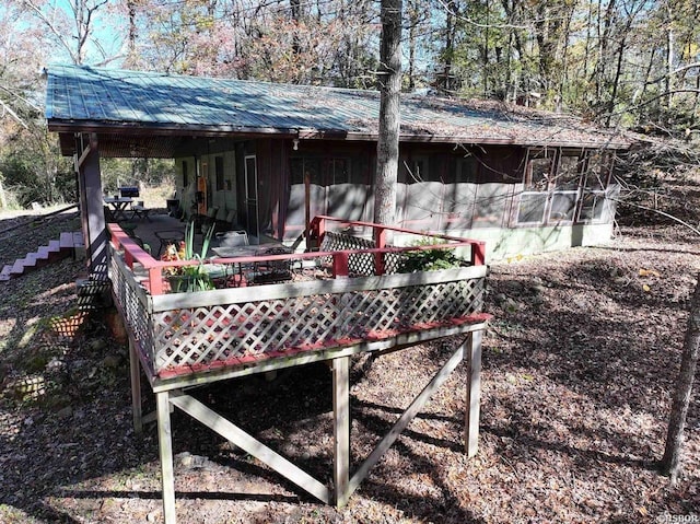 view of outbuilding with stairs and a sunroom