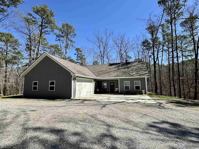 view of home's exterior with driveway, a shingled roof, and a garage