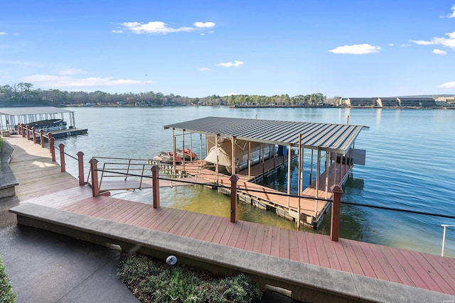 dock area with a water view and boat lift