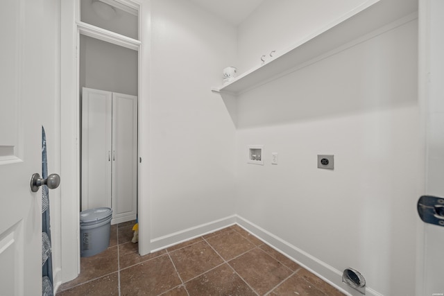 clothes washing area featuring laundry area, baseboards, dark tile patterned flooring, hookup for an electric dryer, and washer hookup