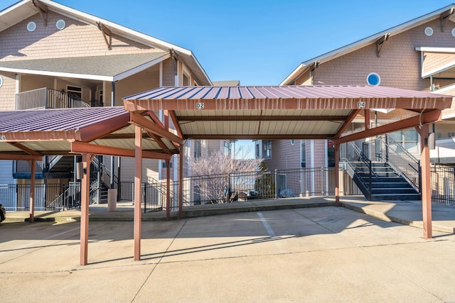 view of property's community with covered parking and fence