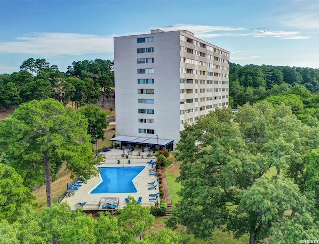 740 Weston Rd Unit A-706, Hot Springs, AR 71913 - view of building exterior featuring a community pool and a view of trees